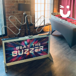 Mega Buzz Wire and Snake Pit games set up inside at a corporate conference
