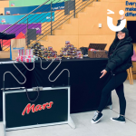 Fun Expert Jenny posing with a branded Mega Buzz Wire for Mars at their promotional stand