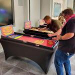 Colleagues playing Carnival Coin Roller Hire