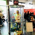 Young man at a student exhibition playing on the Ballnado Hire