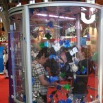 Two girls inside our Cash Grabber Hire during an exhibition