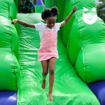 Dino Slide at Fun Day with a young girl running down the end