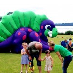 parents with their children at a fun day by the child's slide