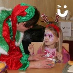 Young girl and elf with gingerbread man christmas ears