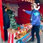 Christmas Funfair Target Tree Stall being enjoyed by a person at an outdoor community event
