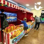 Christmas Funfair 2 Festive stalls set up in a school hall for their end of year bash