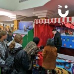 Christmas Hook A Duck Side Stall at a corporate Christmas event with a crowd watching a young girl hook a duck