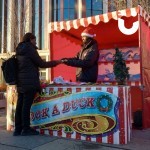 Christmas Hook A Duck Side Stall set up outside some offices with a woman winning a prize
