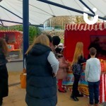 Christmas Hook A Duck Side Stall at a corporate Christmas Family Fun day being enjoyed by a family