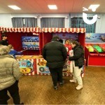 Christmas Hook A Duck Side Stall set up in a school hall with parents and students playing