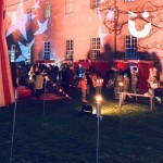 Row of Festive STalls at a community event with families milling around