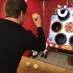 Christmas Ball In A Bucket Stall at an office Christmas party with a man throwing a snowball
