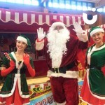 Christmas Snowball Toss Hire with Santa and 2 elves in front waving at the camera