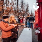 Christmas Funfair Target Stall Hire at an outdoor community event with 2 young girls having a turn to win a novelty prize