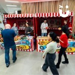 Christmas Funfair Target Stall Hire set up in a large office atrium to entice passers by to have a go at winning a festive prize
