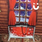 Christmas Gingerbread Man Buzz Wire stood infront of grotto backdrop
