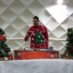 Christmas Tree Buzz Wire set on a table with a man in a festive jumper smiling and having a go