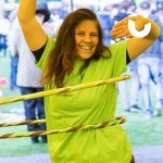 Circus Skills Workshop Hire with a woman hula hooping at a corporate team building event
