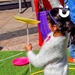 A young girls spinning a plate