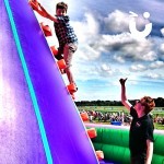 One of our Fun Experts encouraging a young climber at a fun day at Haydock