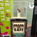Crack the Safe with a bottle of champagne inside ready to be won at an exhibition