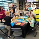 Craft Workshop at a corporate fun day filled with children and parents getting creative