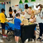 Craft Workshop at a corporate fun day filled with children and parents creating clay models and decorating plant pots