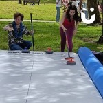 Curling Lane at a corporate fun day being enjoyed by 2 colleagues