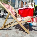 Giant Deckchair Image at a community promotional event being sat on by 2 young women