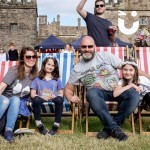 Deckchairs at a fun day with a family beaming at the camera