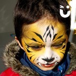 A boy painted as a Tiger from our Face Painting Children Hire 