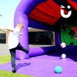 Child kicking the ball into the Football Shoot out