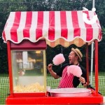 Candy Floss And Popcorn On A Cart Hite at a corporate event with a fun expert pretending to eat 2 large sticks of candy floss