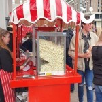 Candy Floss And Popcorn On A Cart 4 Hire at a university event outside with students eating popcorn