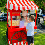 Fun Expert serving Candyfloss from the traditional cart