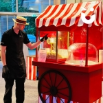 Fun Expert George pointing at Candyfloss and Popcorn on the same cart