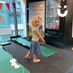 Indoor Putting Golf being enjoyed by a young girl at a corporate fun day