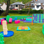 Range of Giant Games set up inside picket fencing