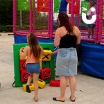 Women and child playing a game of Noughts and Crosses