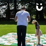 a man and little girl carefully playing the Snakes And Ladders Hire