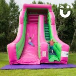 Boy and Girl climbing up the Giant Inflatable Slide Hire