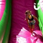 Young girl painted like a tiger on the Giant Inflatable Slide Hire