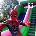 Spider Man having a go on the Giant Inflatable Slide Hire