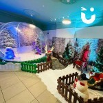 Christmas Giant Snow Globe Hire set up amogst some Christmas theming at a corporate party ready for the fun