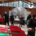 Christmas Giant Snow Globe Hire set up at a Christmas Event with fun seekers milling around