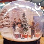 Christmas Giant Snow Globe Hire being enjoyed by 3 children at a community festive event