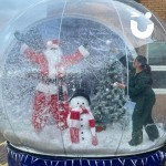 Christmas Giant Snow Globe Hire with Santa himself inside having a snowball fight with a woman who may well be on the naughty list