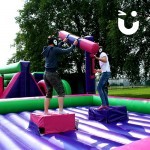 Two contenders in the sun at the Gladiator Joust Hire during a family fun day