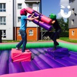 Two students wresting for victory on the Gladiator Joust Hire