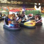 Dodgems Hire 2 at a fun day being used by children and Fun Bear challenging them